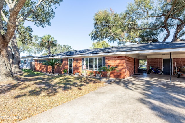 single story home with a front yard and a carport