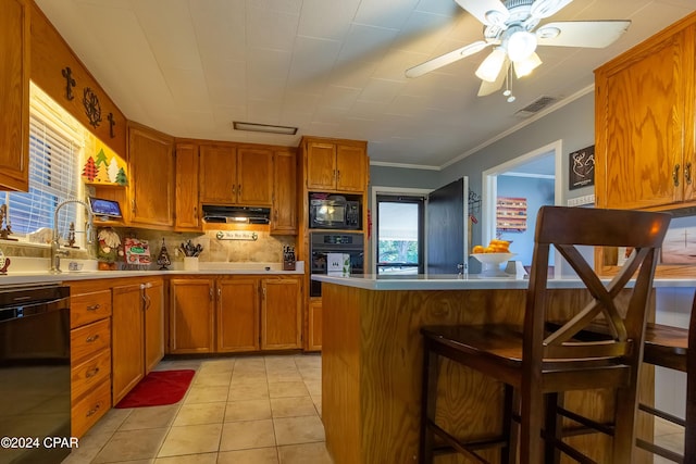 kitchen with a breakfast bar, black appliances, ornamental molding, light tile patterned flooring, and kitchen peninsula