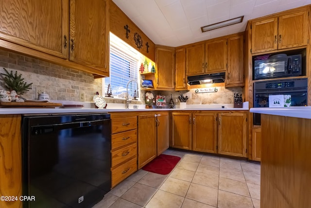 kitchen featuring black appliances, sink, light tile patterned floors, and backsplash