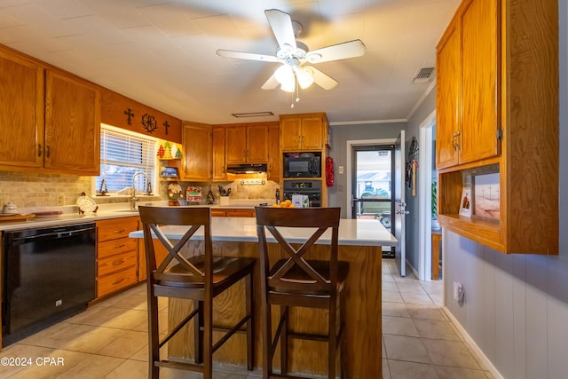 kitchen with a kitchen breakfast bar, ceiling fan, crown molding, black appliances, and light tile patterned floors