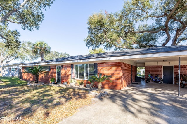 ranch-style home featuring a carport