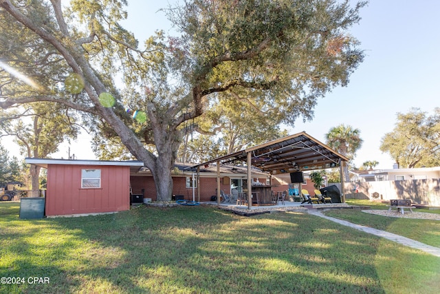 view of yard featuring a patio area and a storage shed