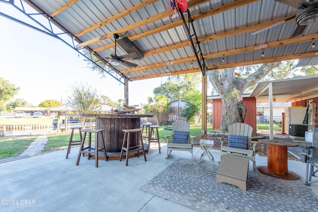 view of patio featuring ceiling fan and an outdoor bar