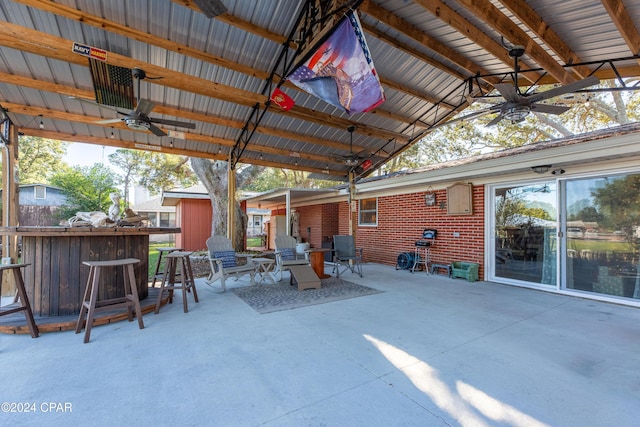 view of patio / terrace featuring a bar and ceiling fan