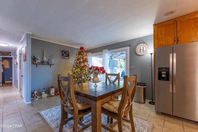 dining room with light tile patterned floors and ornamental molding