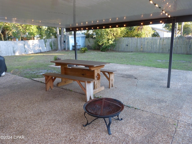 view of patio / terrace with a fire pit and a shed