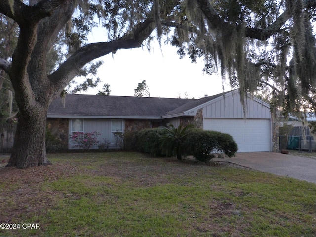 ranch-style home with a front yard and a garage