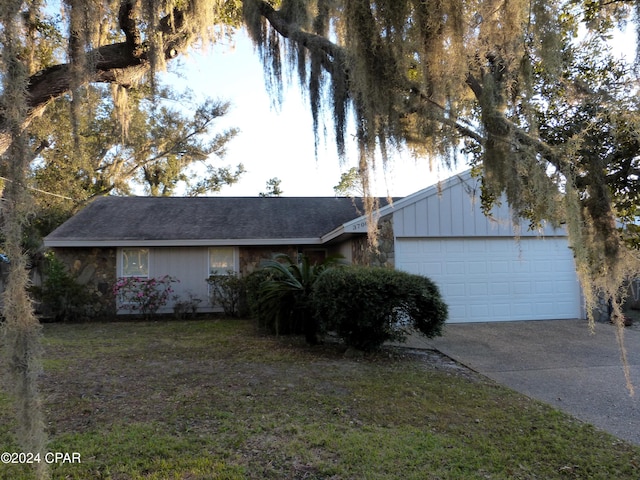 view of front of house with a front yard and a garage