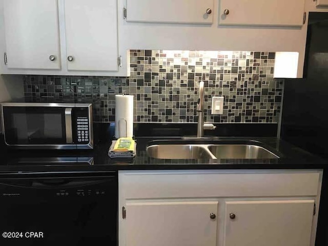 kitchen featuring tasteful backsplash, dishwasher, white cabinets, and sink