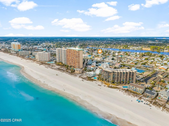 drone / aerial view featuring a view of city, a water view, and a view of the beach