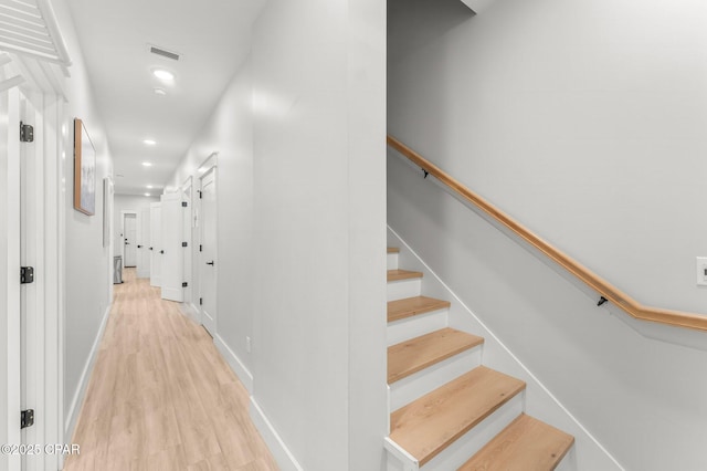 stairs with recessed lighting, visible vents, baseboards, and wood finished floors