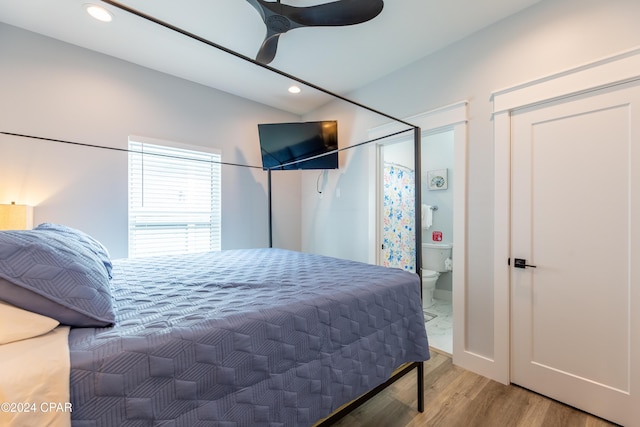 bedroom with hardwood / wood-style floors, ceiling fan, and connected bathroom