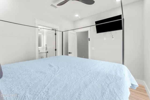 7026 Thomas Dr Unit A & B, Panama City Beach, FL 32408 - bedroom featuring wood finished floors, connected bathroom, and a ceiling fan