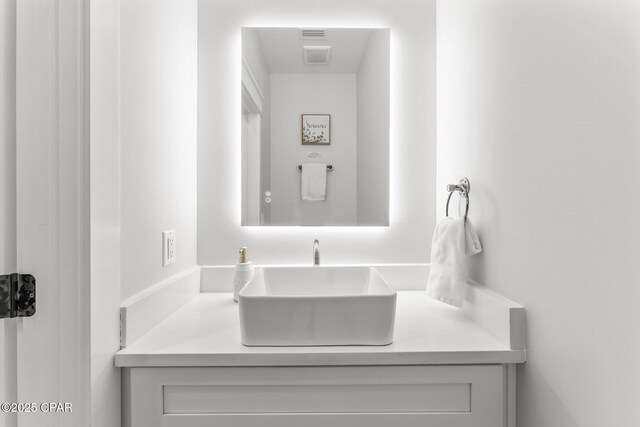 bathroom featuring tiled shower, wood-type flooring, and vanity