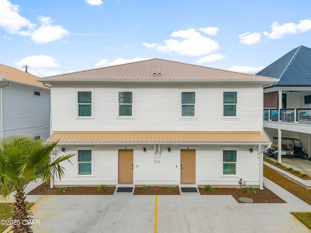 townhome / multi-family property featuring metal roof