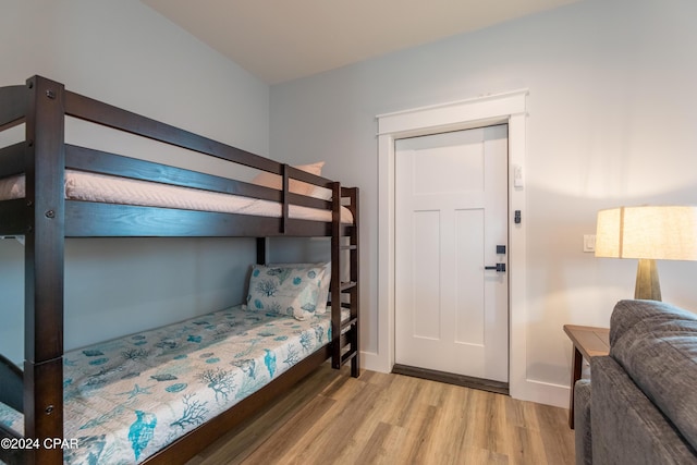 bedroom with light hardwood / wood-style floors and a closet