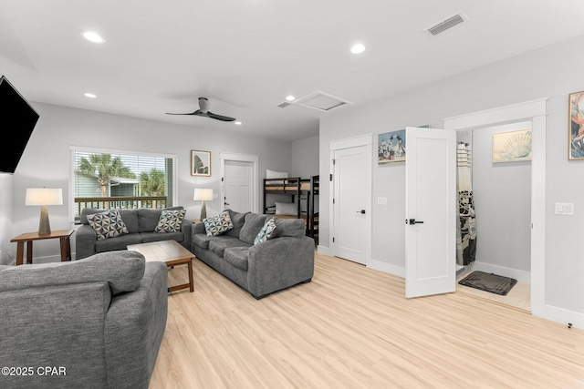 living room featuring light wood-style flooring, recessed lighting, visible vents, baseboards, and attic access