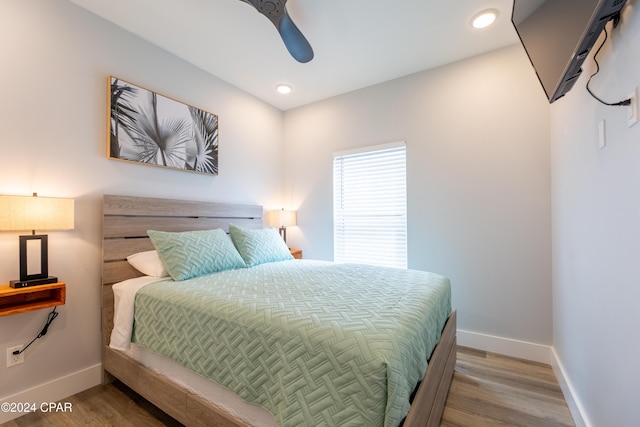 bedroom with hardwood / wood-style floors and ceiling fan