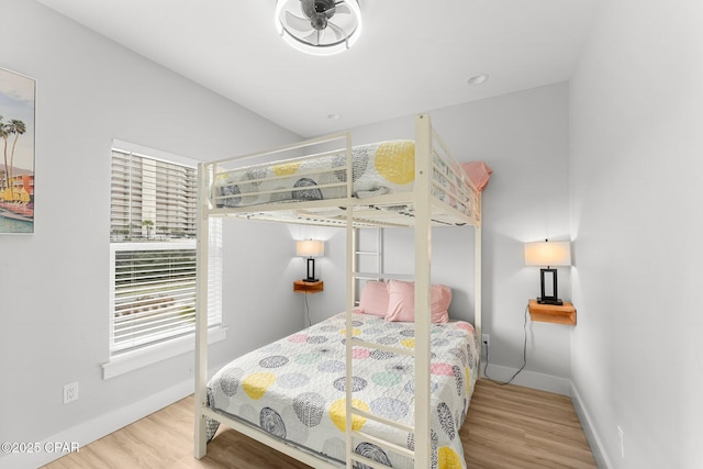 bedroom featuring baseboards and wood finished floors