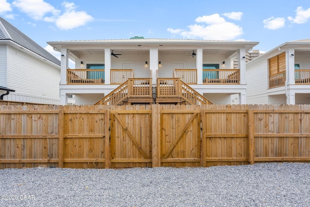7026 Thomas Dr Unit A & B, Panama City Beach, FL 32408 - gate with a ceiling fan, stairway, and a porch