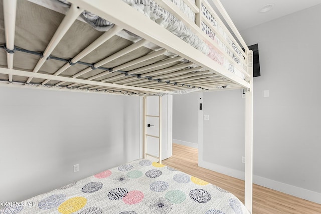 7026 Thomas Dr Unit A & B, Panama City Beach, FL 32408 - unfurnished bedroom featuring wood finished floors and baseboards