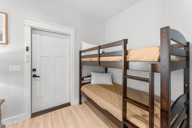 bedroom featuring light wood-type flooring and baseboards