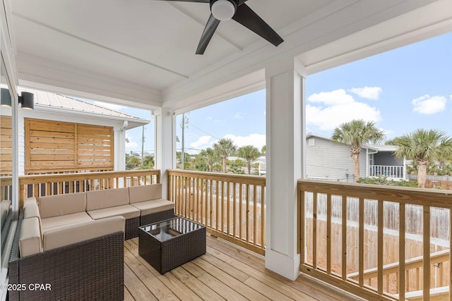 wooden terrace with outdoor lounge area and a ceiling fan