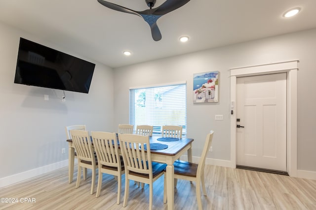 dining space with light hardwood / wood-style floors and ceiling fan