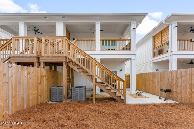 7026 Thomas Dr Unit A & B, Panama City Beach, FL 32408 - rear view of property featuring a ceiling fan, a fenced backyard, and stairs
