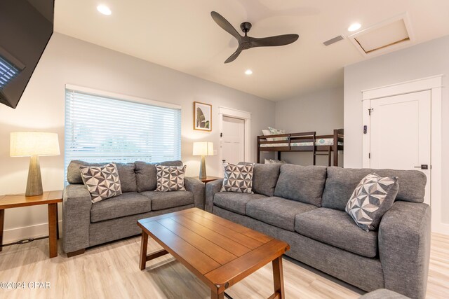 living room featuring ceiling fan and light hardwood / wood-style floors