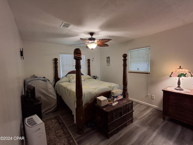 bedroom with dark hardwood / wood-style floors and ceiling fan