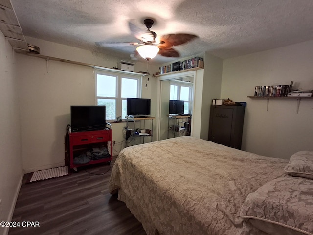 bedroom featuring a textured ceiling, dark hardwood / wood-style floors, and ceiling fan