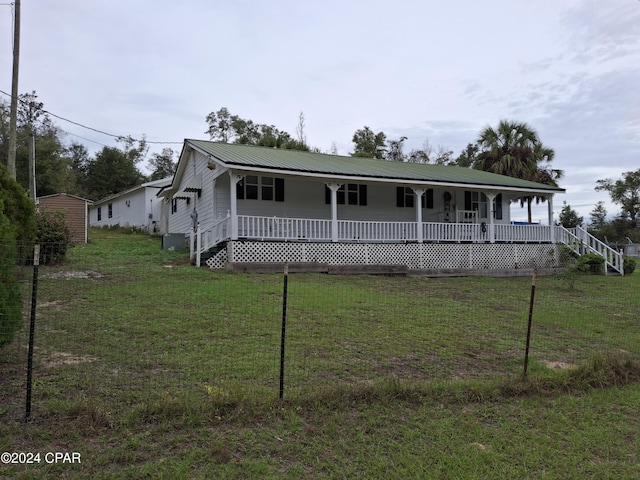 view of front of house with covered porch and a front lawn