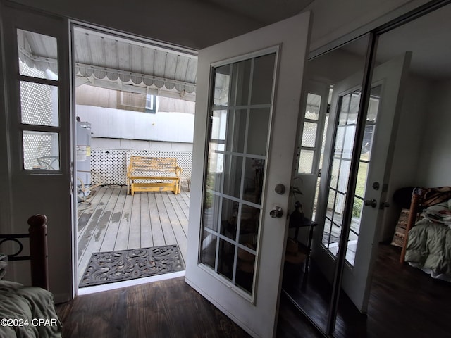 doorway featuring french doors, dark hardwood / wood-style flooring, and a healthy amount of sunlight