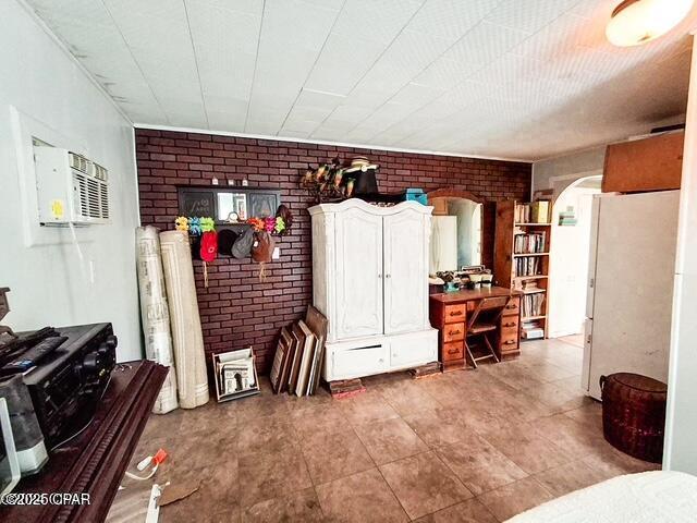 interior space featuring arched walkways and brick wall