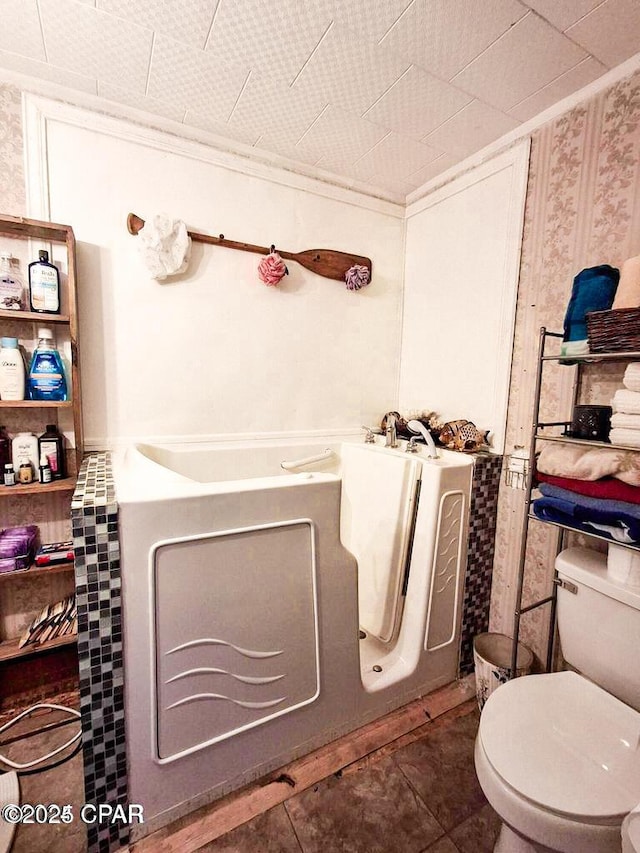 bathroom featuring toilet and tile patterned flooring