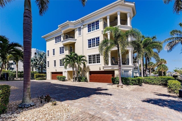 view of front of property featuring decorative driveway and stucco siding