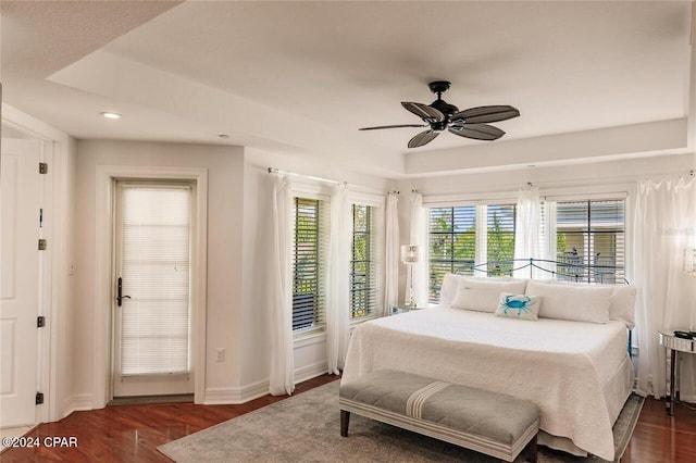 bedroom with ceiling fan and dark wood-type flooring