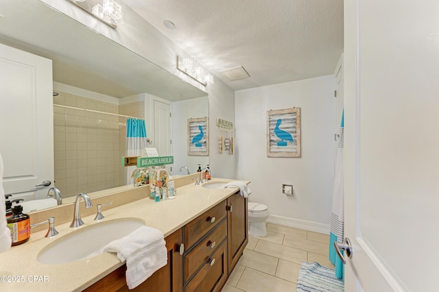 full bathroom featuring toilet, a textured ceiling, a sink, and tile patterned floors