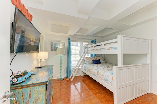 bedroom featuring coffered ceiling, baseboards, and wood finished floors