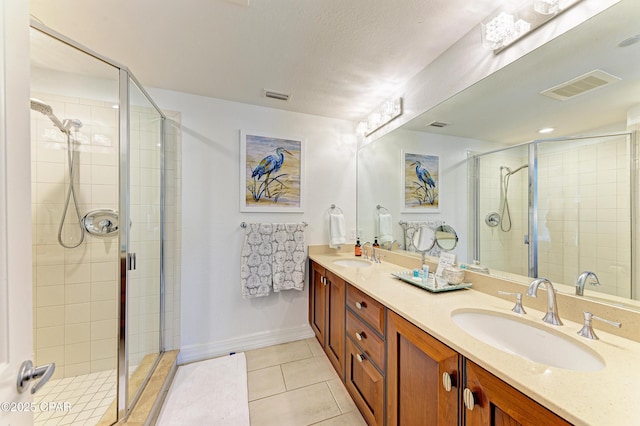 full bath featuring a sink, visible vents, and tile patterned floors