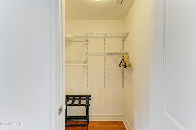 spacious closet with wood finished floors and visible vents