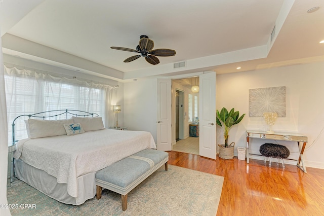 bedroom with recessed lighting, visible vents, baseboards, a ceiling fan, and light wood finished floors