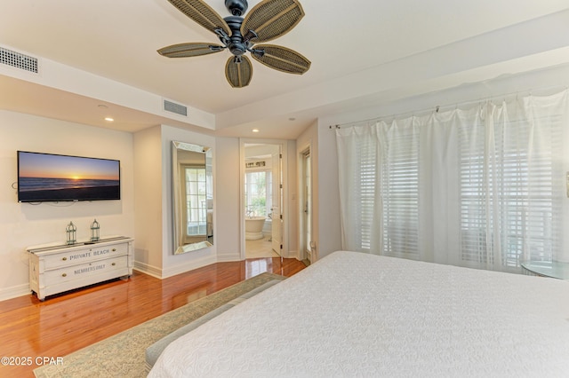 bedroom featuring baseboards, visible vents, wood finished floors, and recessed lighting