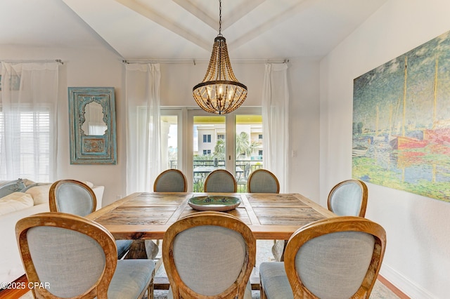 dining area with baseboards and a notable chandelier