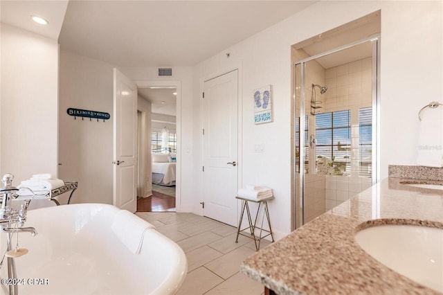 bathroom featuring visible vents, a soaking tub, ensuite bath, vanity, and a shower stall