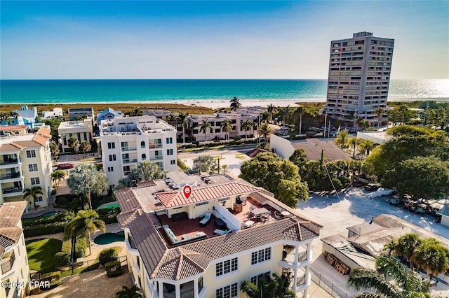 birds eye view of property featuring a water view and a beach view