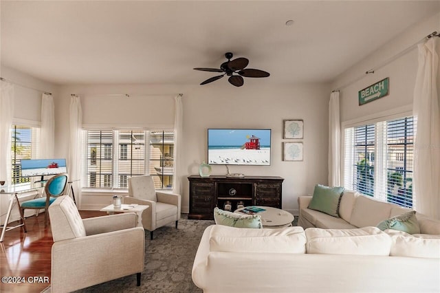 living room with ceiling fan and dark wood-type flooring