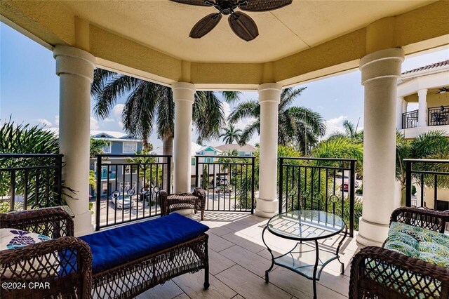 exterior space featuring ceiling fan and a balcony