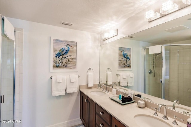 bathroom featuring vanity and an enclosed shower